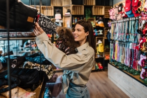 Woman Shopping in Modern Pet Shop Together with Her Dog
