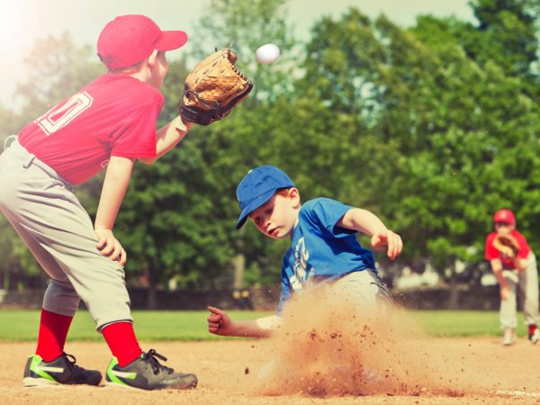 Boy sliding into base during a baseball game with Instagram style filter