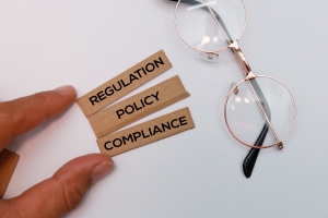 Hand Holding Sticks With Words Regulation Policy and Compliance