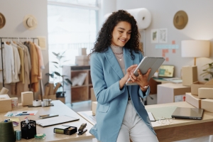 Happy Female Retail Business Owner Checking ROI in Tablet