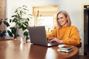 Woman Working on Laptop Remotely from Home