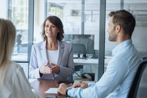 Female Insurance Agent Explaining Supply Chain Insurance Needs to Retail Business Owners