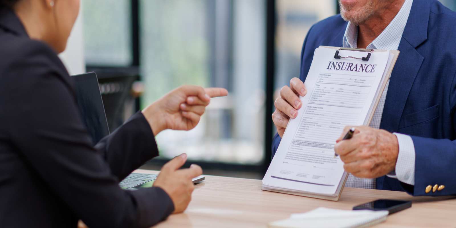 Insurance Agent Showing- Businesswoman Place for Signature on Paper Contract Document