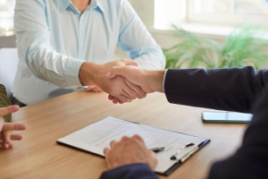 Pet Shop Owner Shaking Hand with Insurance Agent After Buying A Policy