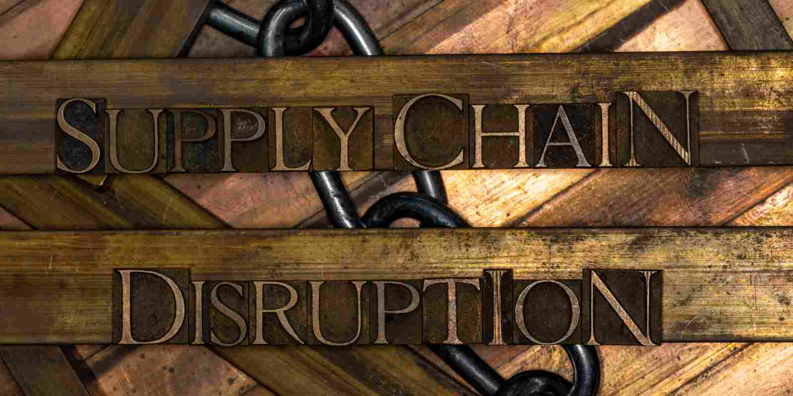 Supply Chain Disruption Text with Steel Chain on Vintage Textured Background