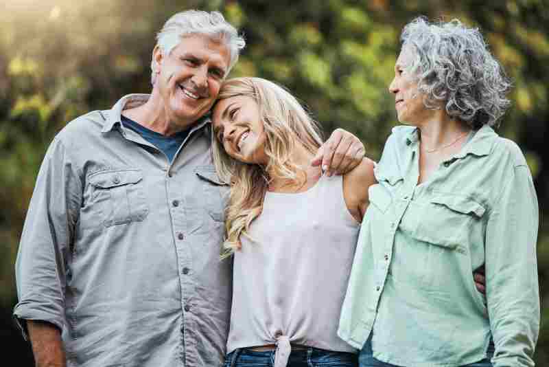 senior parents and hug with daughter to bond on weekend