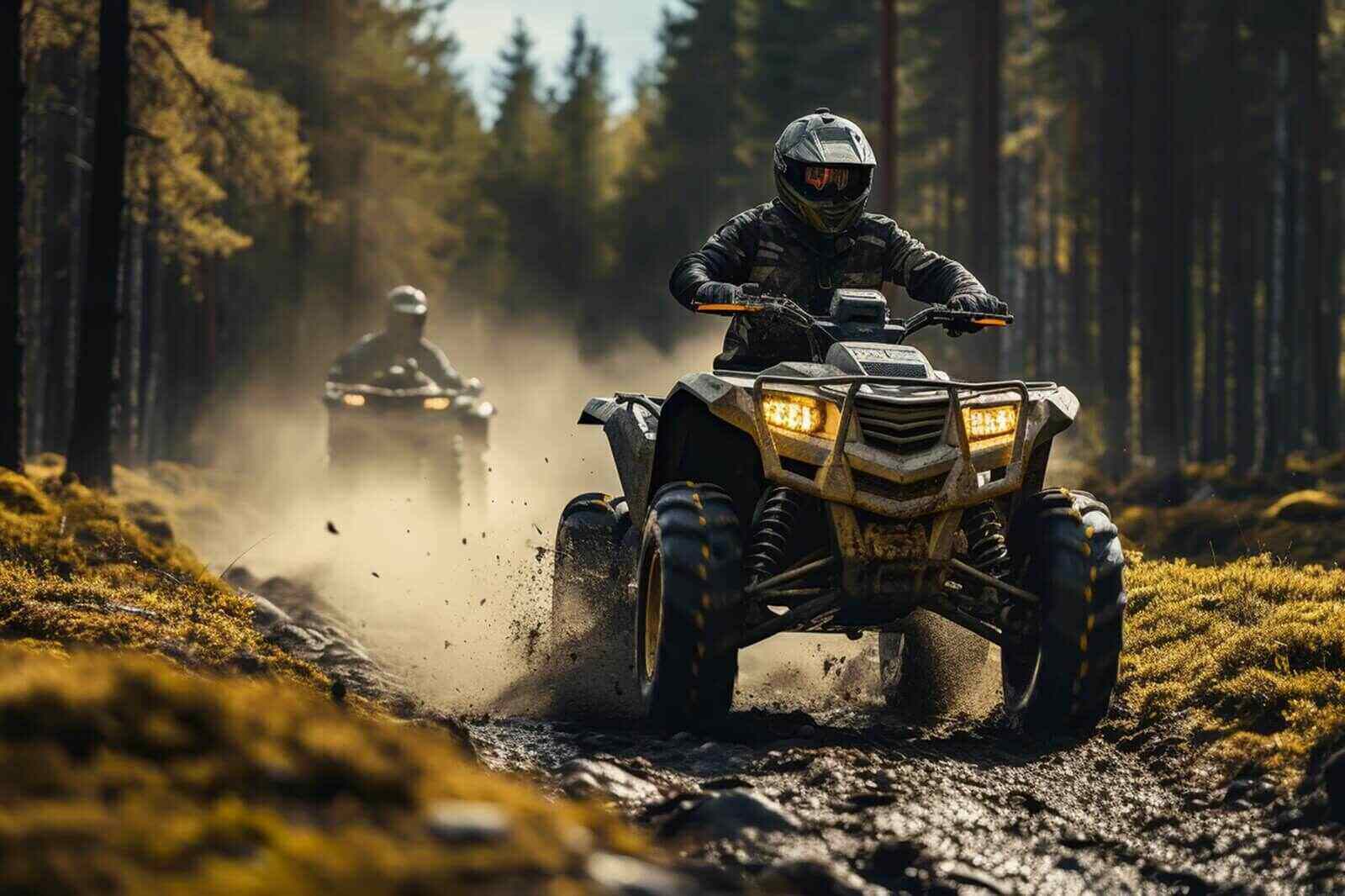 a quad moving trough the mud with two riders on it