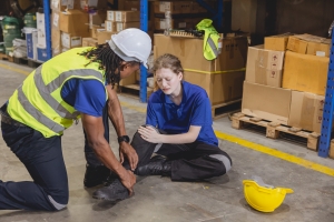 Man Helping his Injured Colleague while Working in A Warehouse