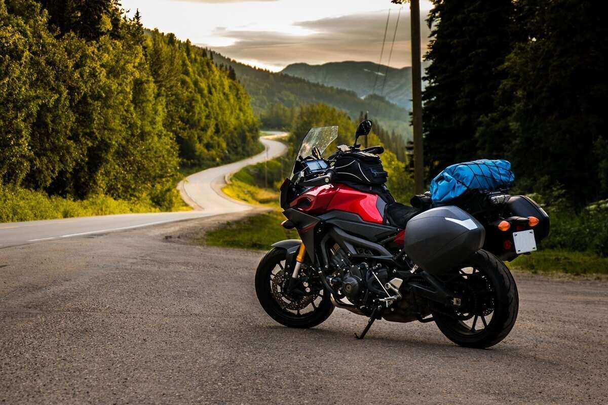 motorcyle parked near a twisty road