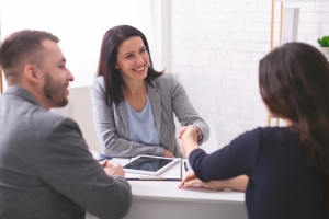 Smiling Insurance Broker Handshaking with Business Owners