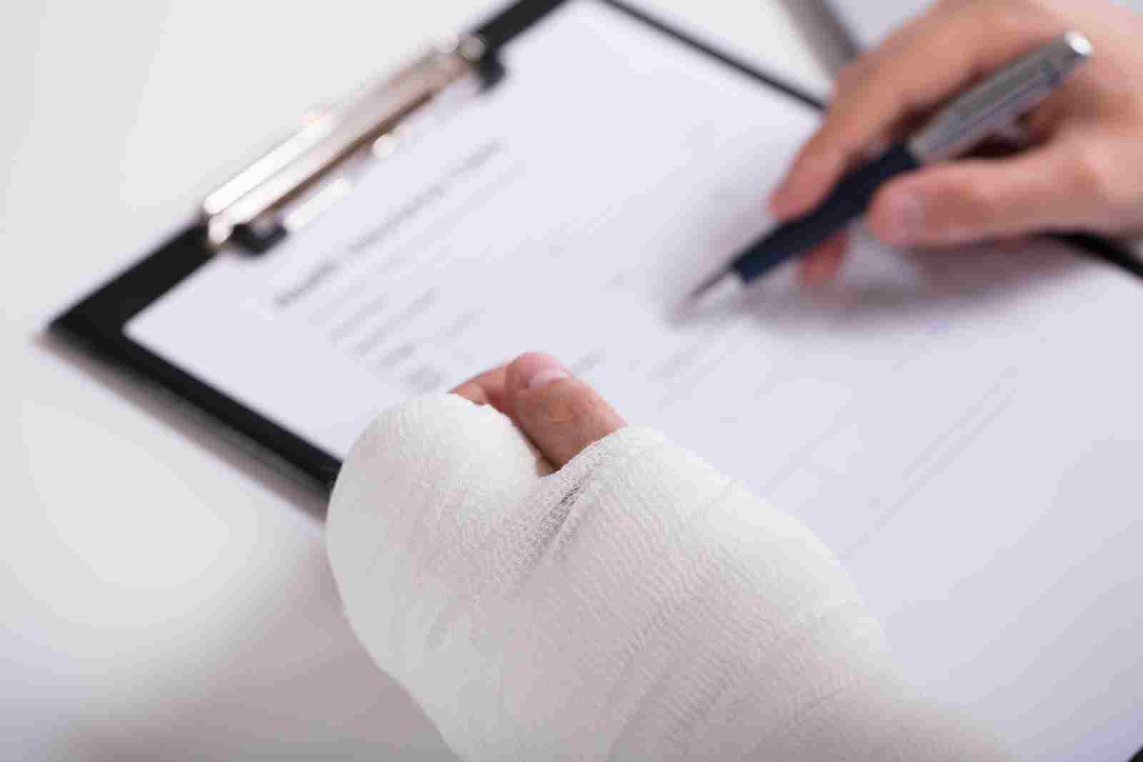 Person With Fractured Hand Filling short-term disability insurance
