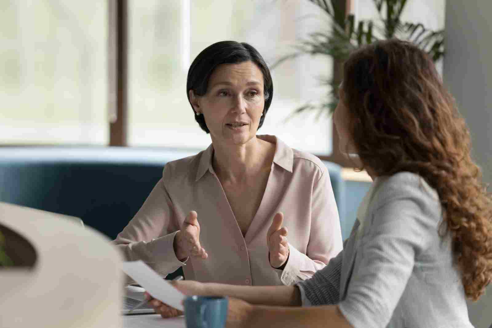 Confident mature business professional talking about short term insurance