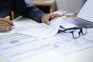 Businessman Reviewing Classification Codes on Business Insurance Documents