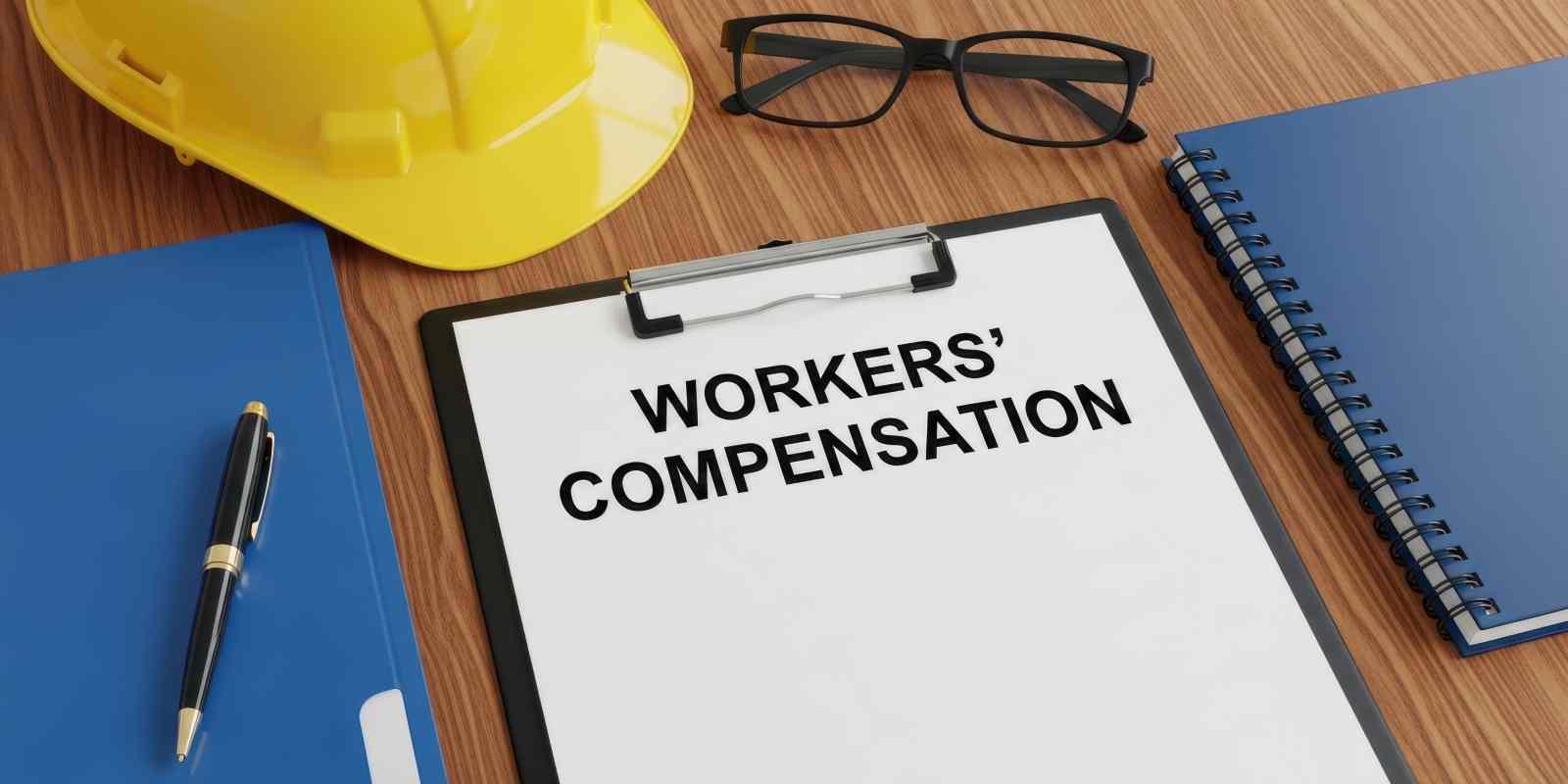 Workers Compensation Document on A Desk with Safety Gear