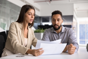 Agent Showing Workers Compensation Insurance Policy to Warehouse Owner