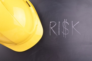 Risk Text with Yellow Hard Hat Representing Risk Management at Site