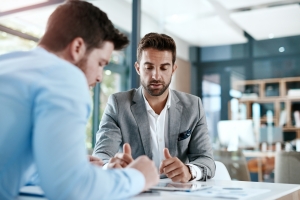 Agent Explaining Workers Compensation Insurance to Delivery Business Owner