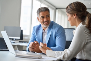 Female Insurance Agent Explaining Workers Compensation Insurance Options to Logistics Business Owner