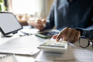 Businessman Making Budget for Workers Compensation Insurance