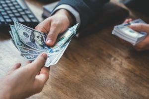 Businessman Paying Workers Compensation Insurance Premium to Agent