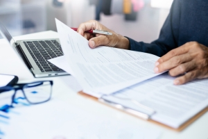 Businessman Reading Classification Codes in Workers Comp Policy
