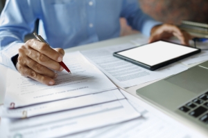 Businessman Reviewing Workers Compensation Insurance Documents Before Renewing