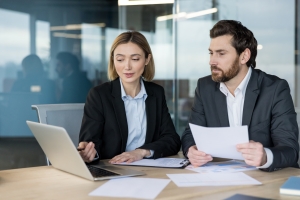 Businessman Reviewing Workers Compensation Insurance Documents with Agent