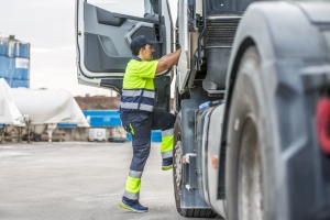 Driver Climbing Steps Into Truck for Trip