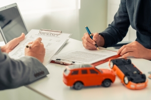 Car Wash Operator Making Pre-Opening Package with Insurance Agent