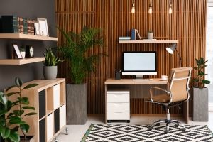 Comfortable Home Office with Computer Near Wooden Wall in Stylish Room Interior