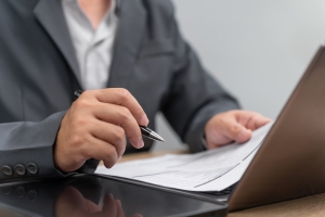 Healthcare Employer Reviewing Workers Compensation Insurance Documents