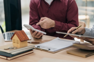 Homeowner Reviewing Home Insurance Update for Renovation with Agent