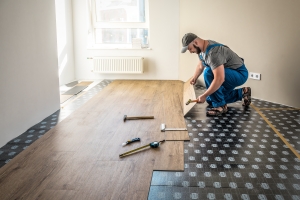 Professional Worker Joining Vinyl Floor Covering at Home Renovation