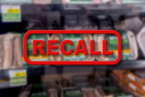 Blurred Background of Vegetarian Meat Products for Sale with the Red Text Recall in the Foreground
