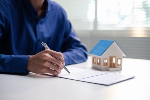 Person Reviewing Home Insurance Application at a Desk